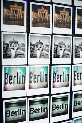 A grid of photos displaying various views and artistic representations of Berlin, including images of the Brandenburg Gate in color and black and white, as well as stylized text images of the word 'Berlin'.
