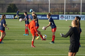 Young soccer players practicing drills on a grassy field.