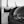 A close-up view of a nautical compass mounted on a boat's deck, with blurred background elements suggesting the boat's structure. The compass's markings are clearly visible, and the image is in grayscale, enhancing its timeless and classic feel.