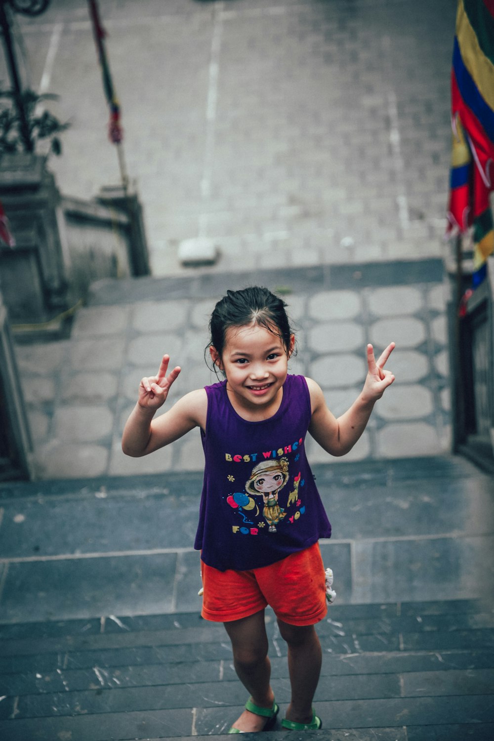 girl showing peace sign