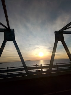 Sunset casting golden light over a completed bridge project showcasing structural details.