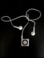 Close-up of stylish headphones resting on a sleek digital audio player