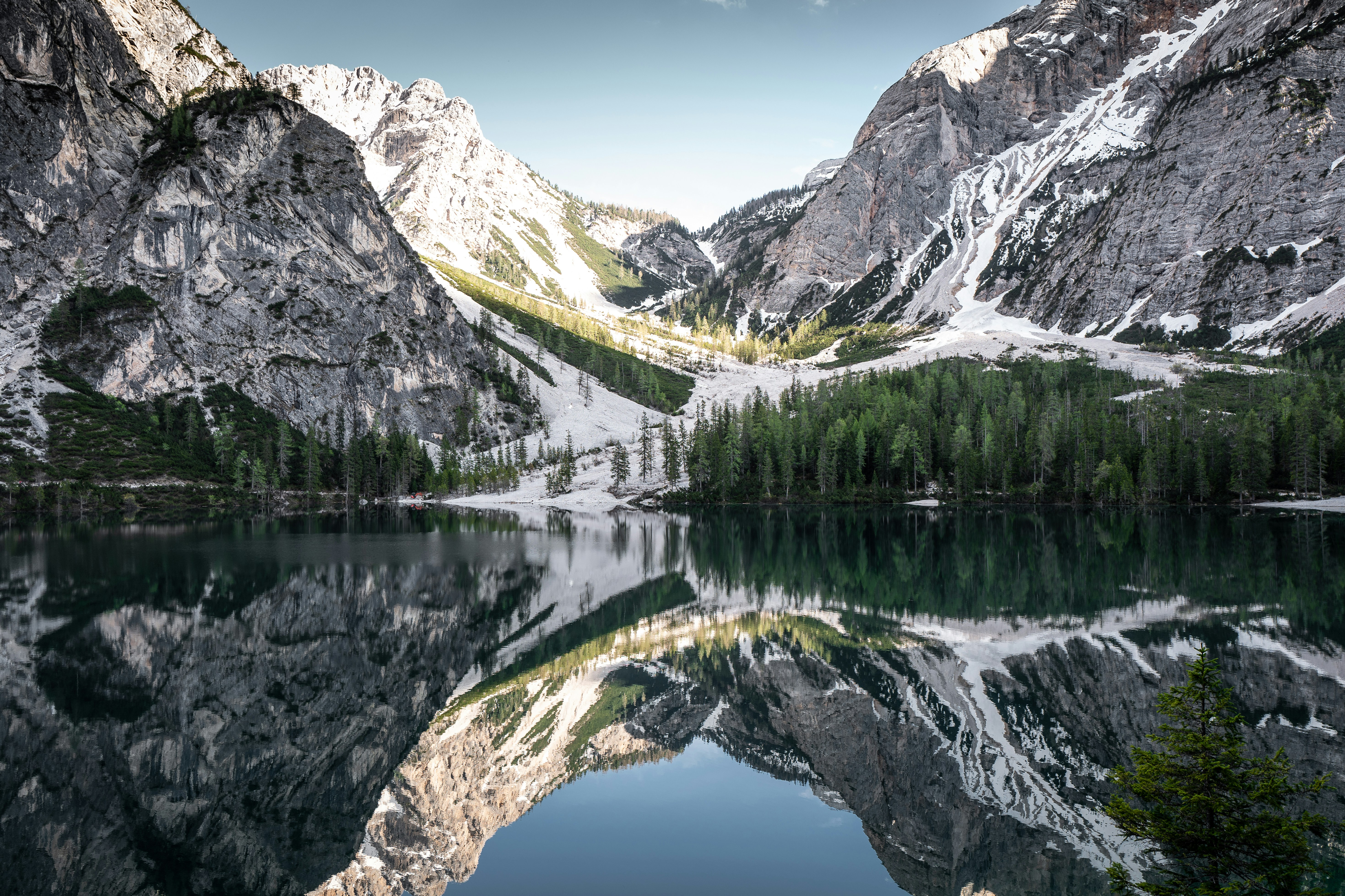 mountain reflected on body of water at daytime