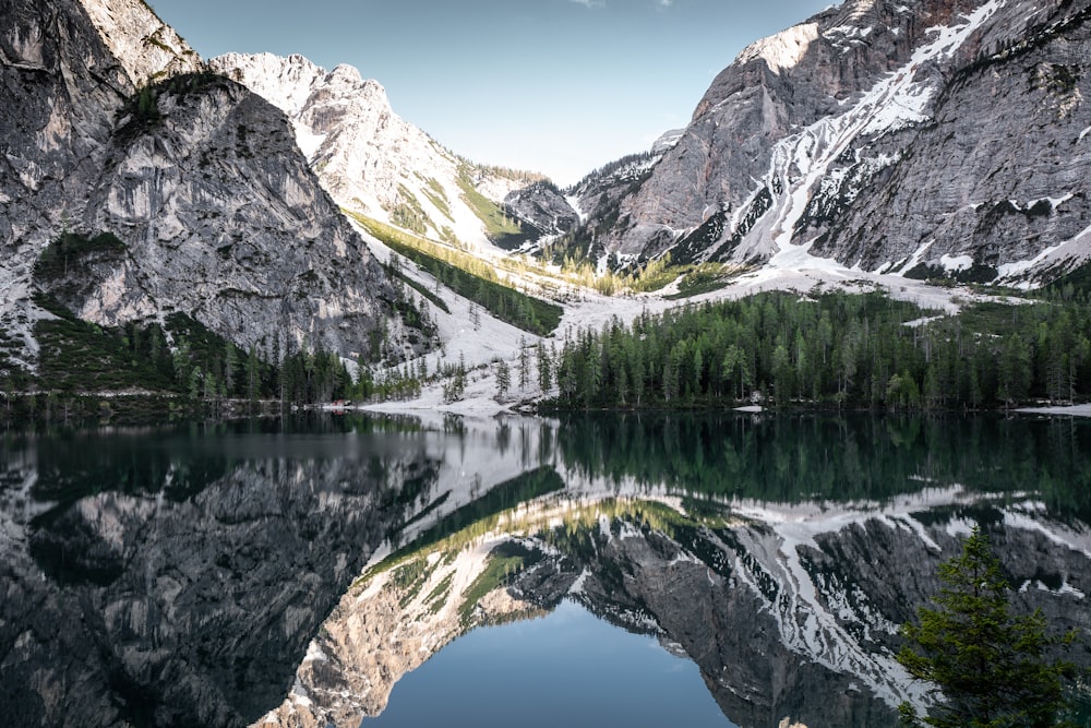 mountain reflected on body of water at daytime