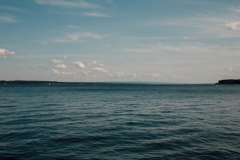 body of water under blue sky