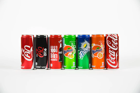 seven assorted-brand soda cans
