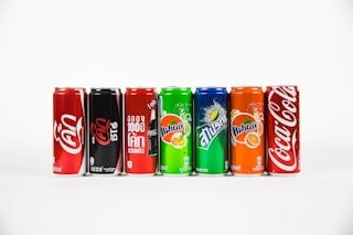 seven assorted-brand soda cans