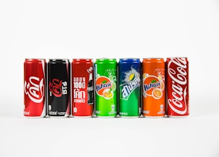 seven assorted-brand soda cans