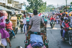 selective photography of man pedaling wagon