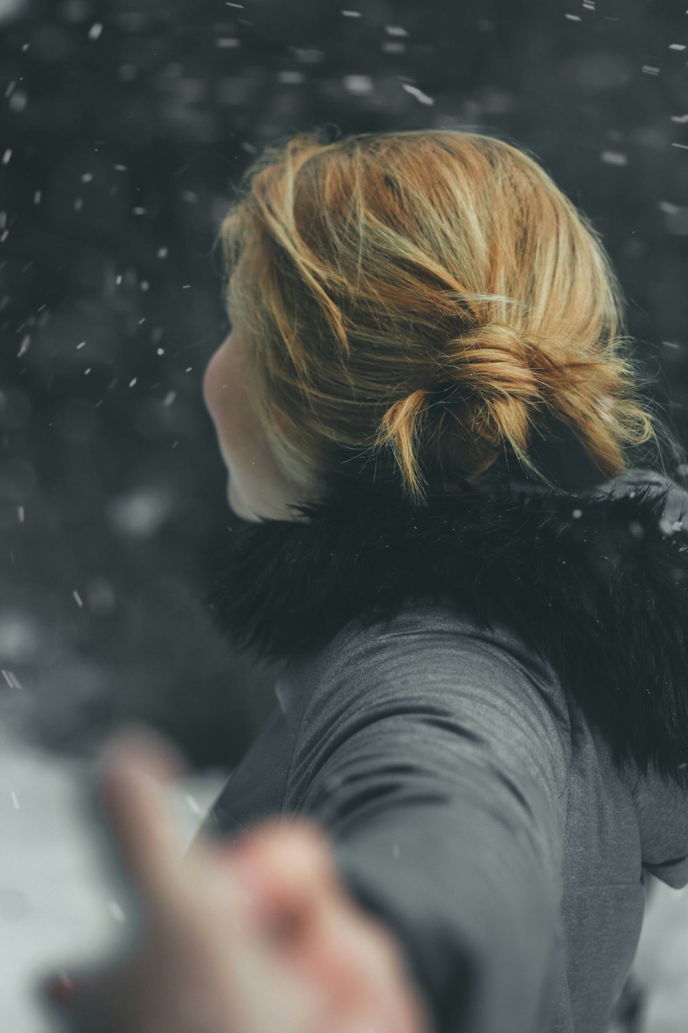 blonde-haired woman in black parka jacket