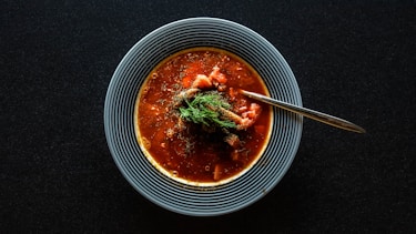 soup with vegetable on gray bowl