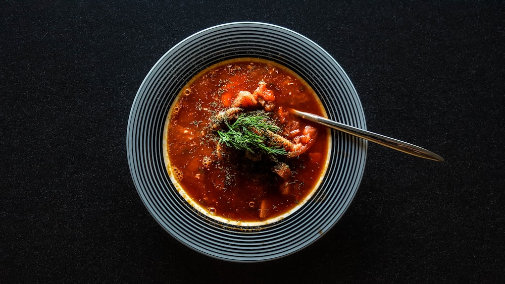 soup with vegetable on gray bowl