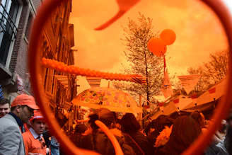 A lively street scene in Oak City during a community festival with colorful banners and smiling faces.