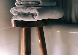 white towels on brown wooden stool