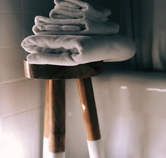 white towels on brown wooden stool