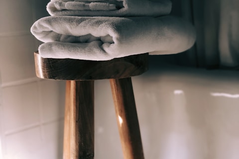 white towels on brown wooden stool