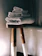 Close-up of a plush, handloom bath towel draped over a wooden rack in a cozy bathroom.