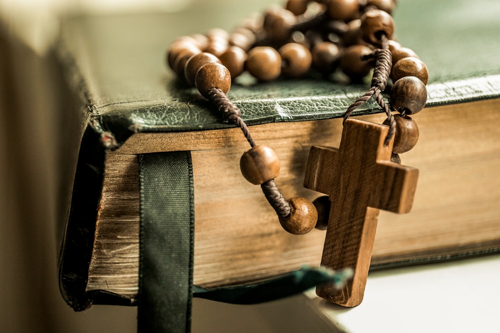 brown tesbih prayer beads on black book