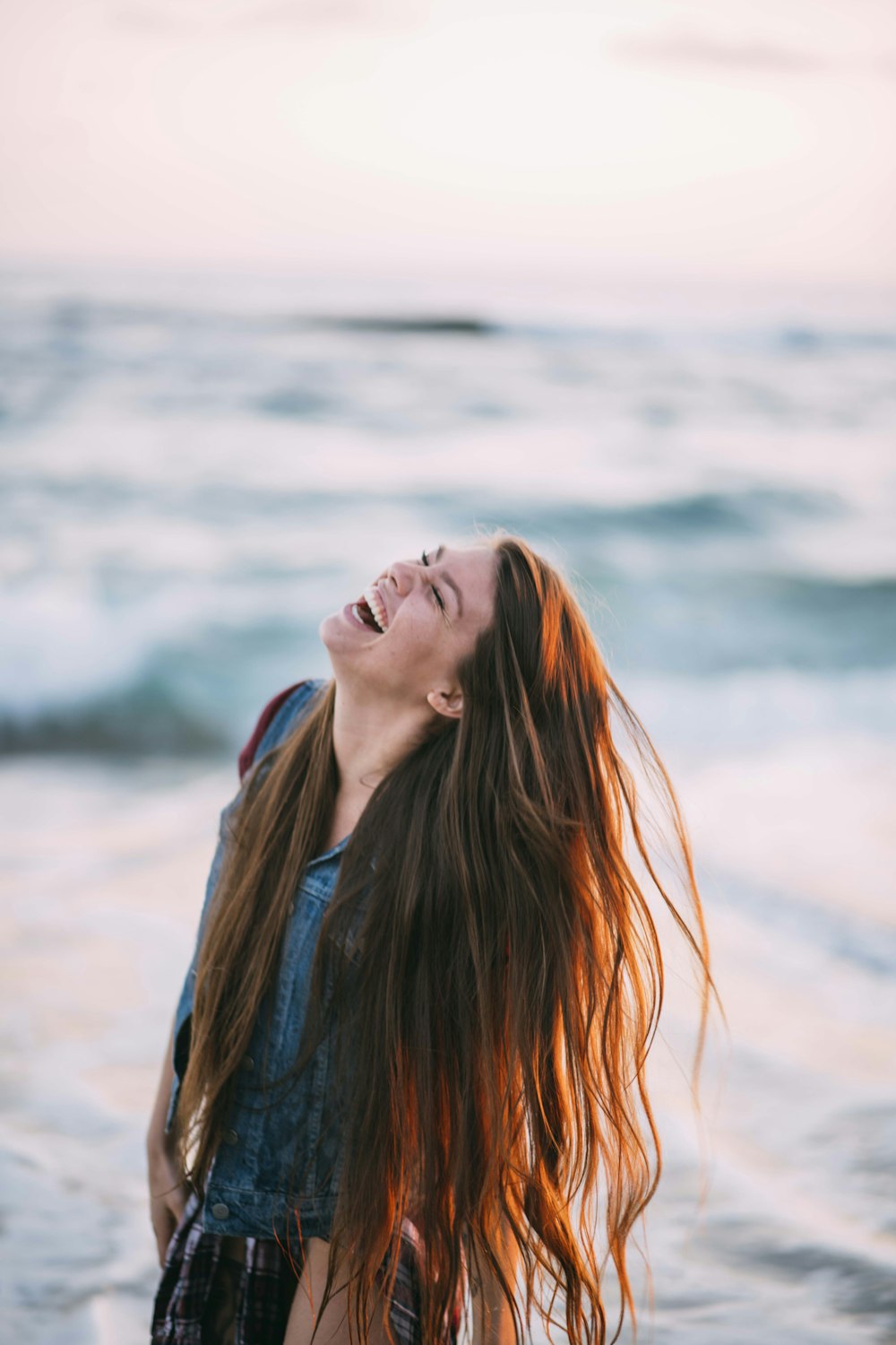 woman in blue denim top taking a photo