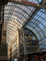 Exterior view of a large shopping mall with waterproofing work in progress.