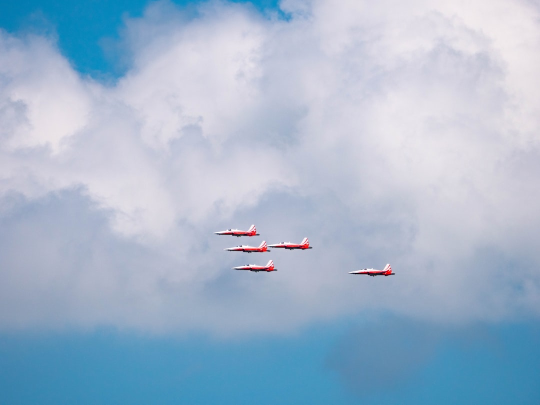 five red-and-white planes in flight, patrouille suisse show