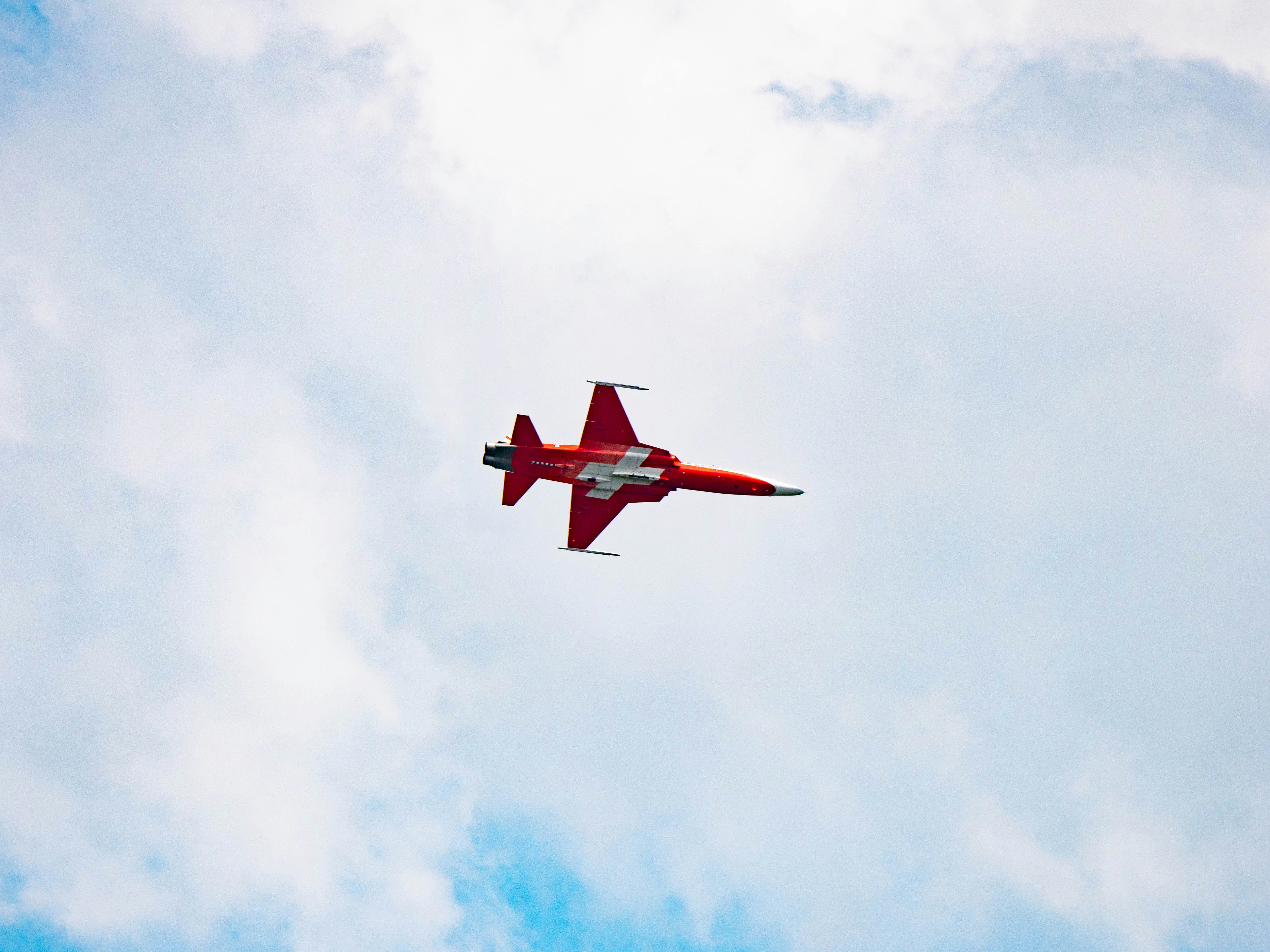 red and white plane in air, patrouille suisse show