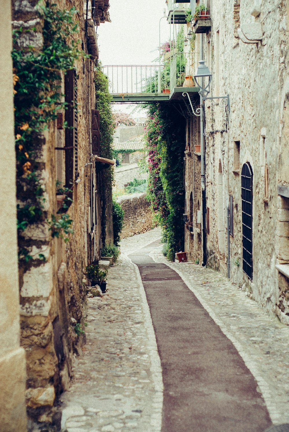 narrow pathway surrounded by concrete of buildings