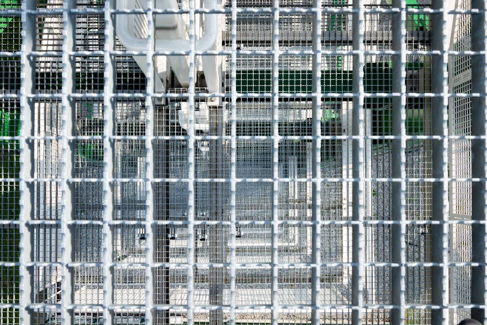 a white toilet sitting inside of a metal cage