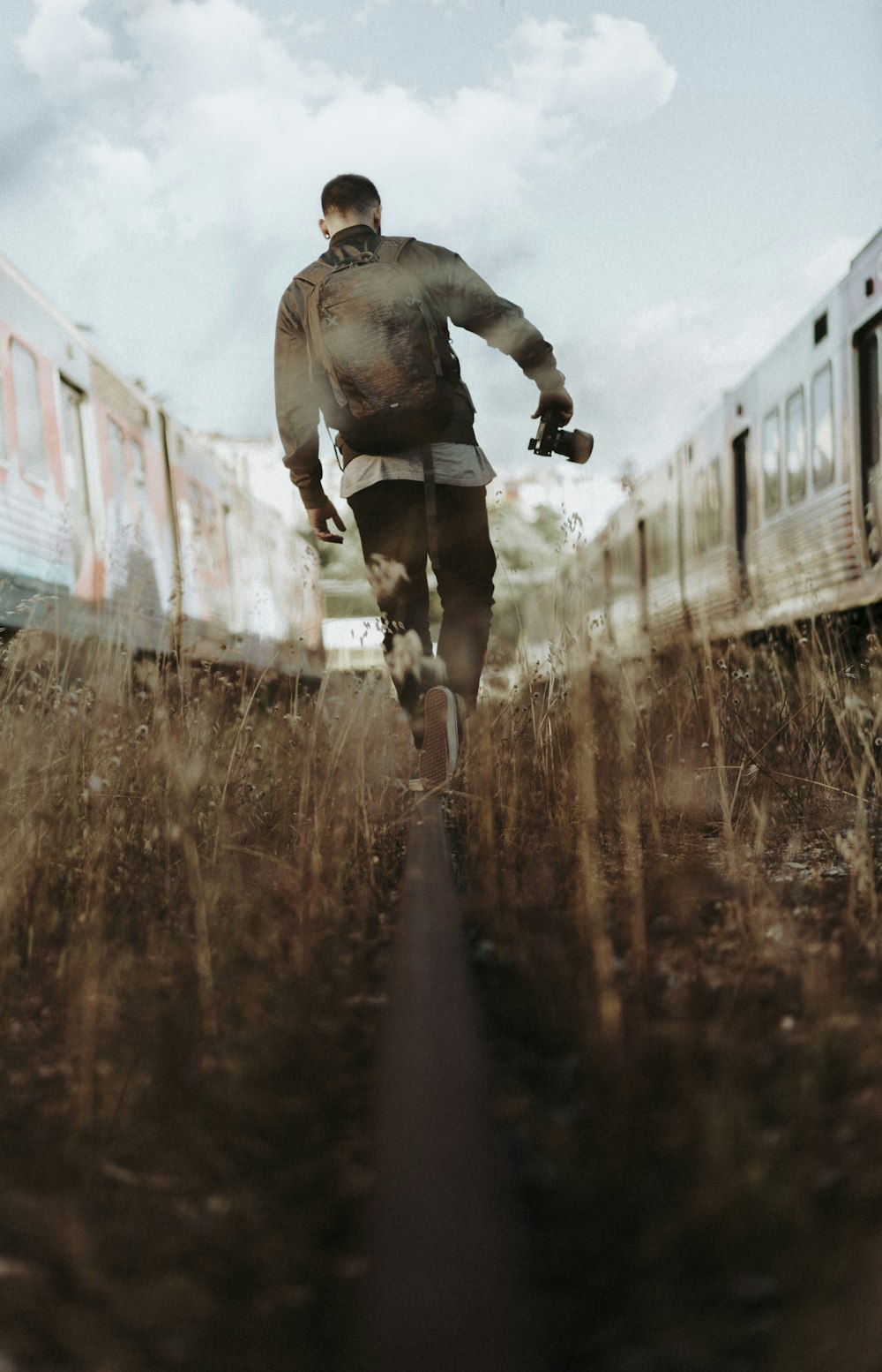 man walking between of train wagons