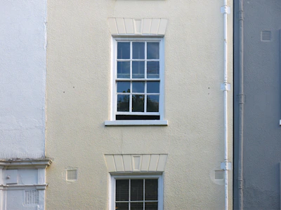 A freshly painted exterior wall in soft cream color with clean edges.