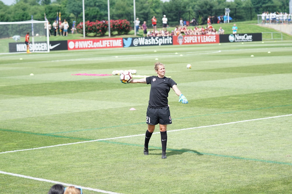 woman throwing soccer ball on soccer field