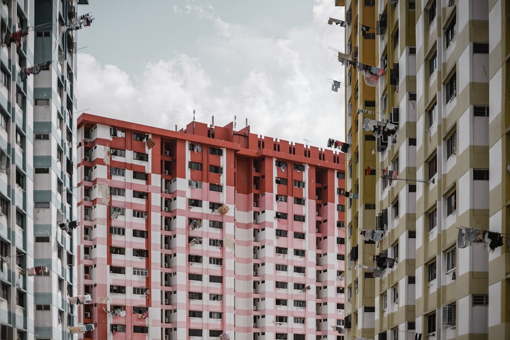 three white, red, and brown high-rise buildings