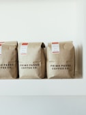 three brown Primo Passo Coffee co packs