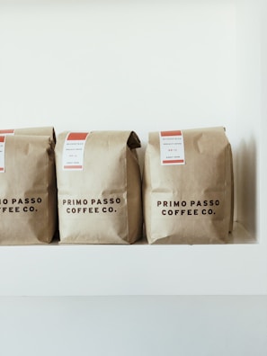 three brown Primo Passo Coffee co packs