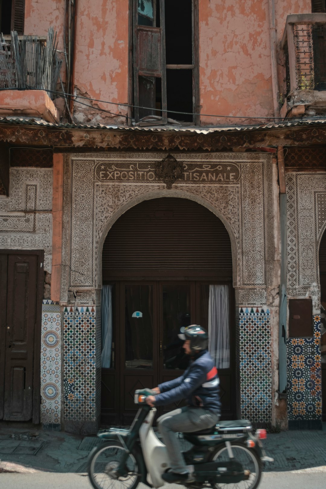 man wearing black jacket riding on motorcycle during daytime