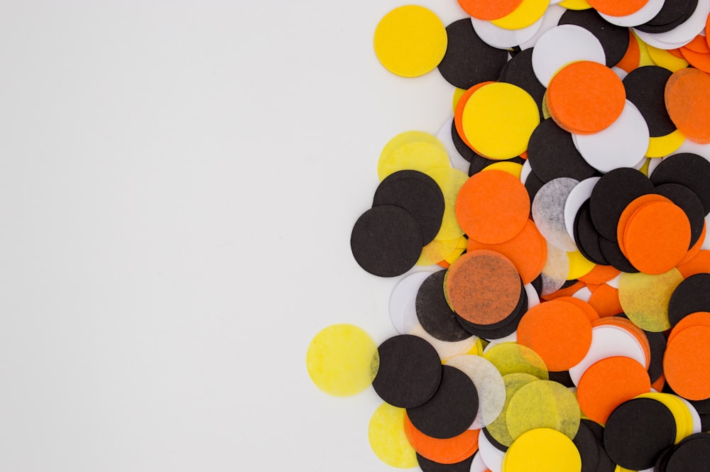 round assorted-color orange, white, and black paper decors