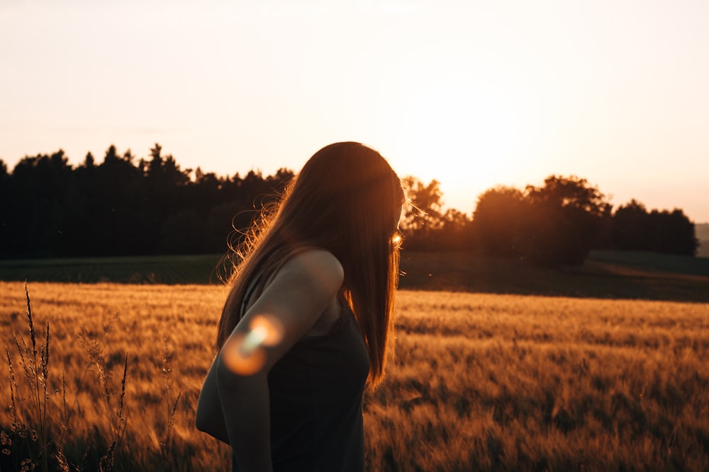 woman standing on brown grass field