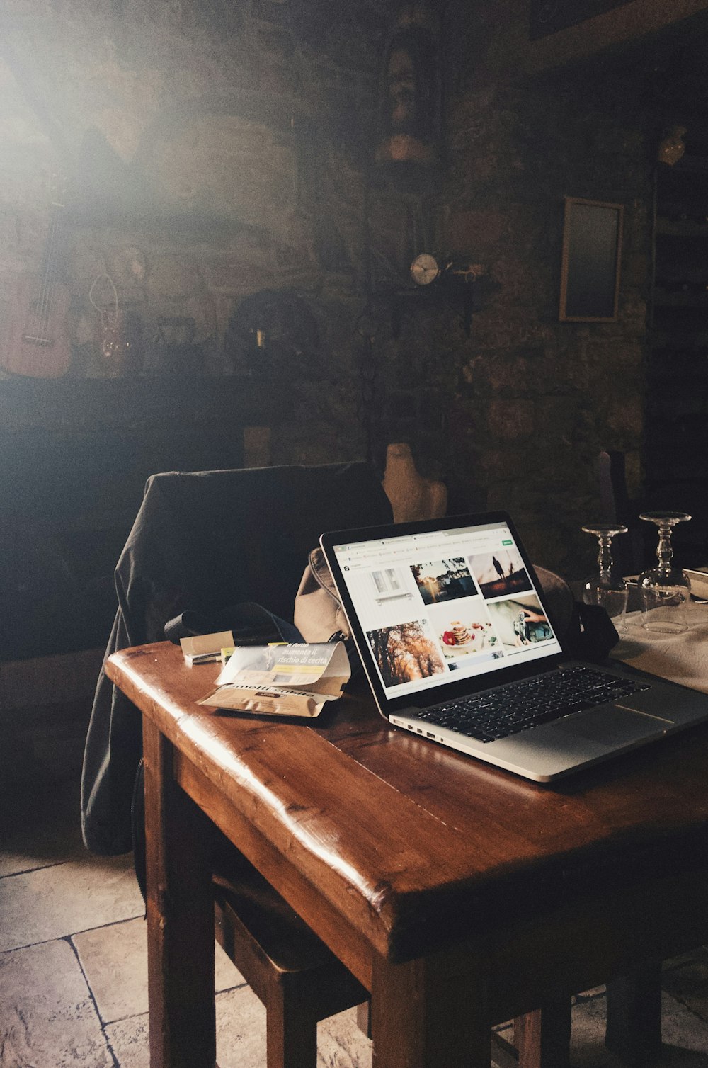 a laptop computer sitting on top of a wooden table