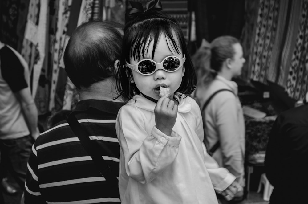 greyscale photo of child eating