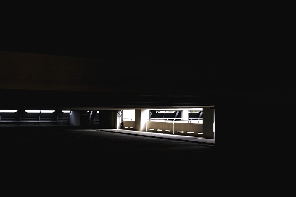 a dark parking garage with the door open