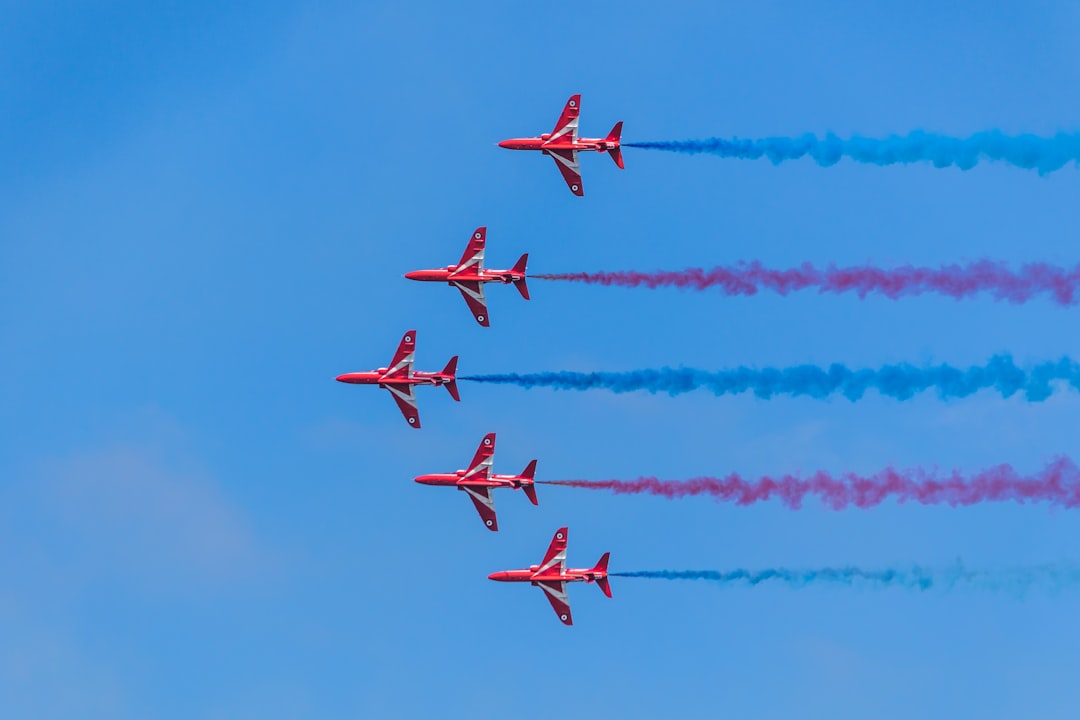 five red planes in sky, Red Arrows at the Torbay Airshow. The Torbay airshow is held annually in early June.
