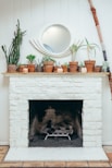 assorted pots on top of white fireplace