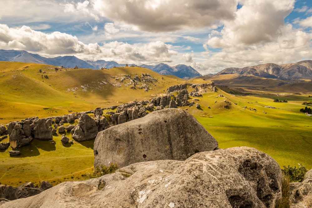 landscape photo of rocks on green grass field