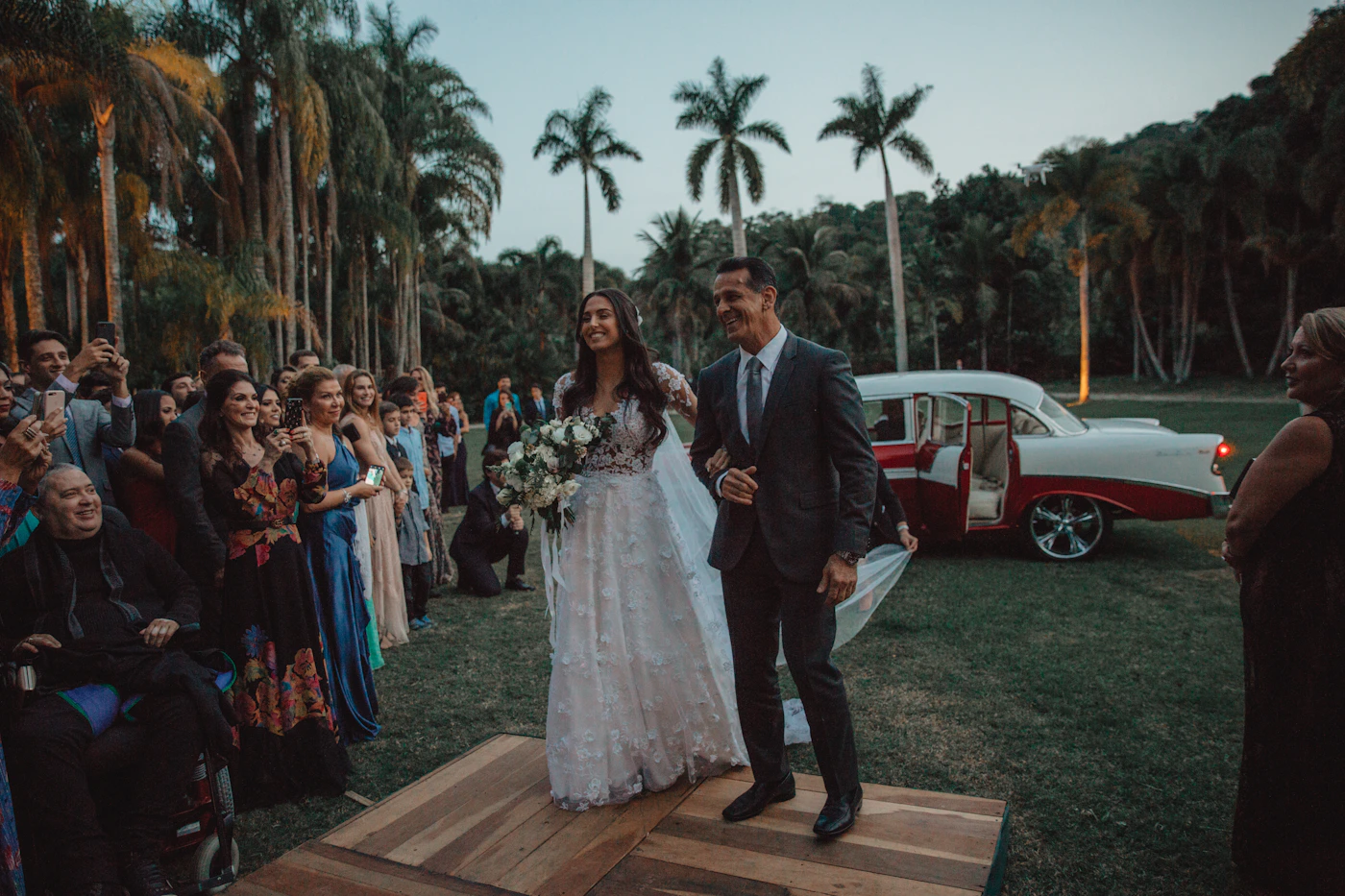 Couple in elopement attire standing in a dense Ecuadorian cloud forest with the mist visible in the canopy and green vegetation surrounding them