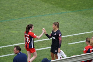 two woman holding there hands