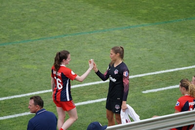 two woman holding there hands