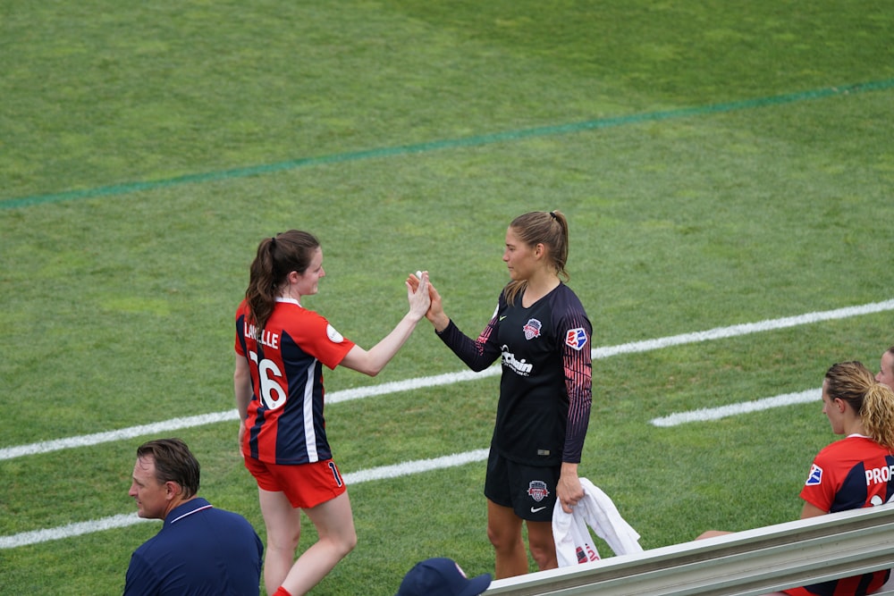 two woman holding there hands