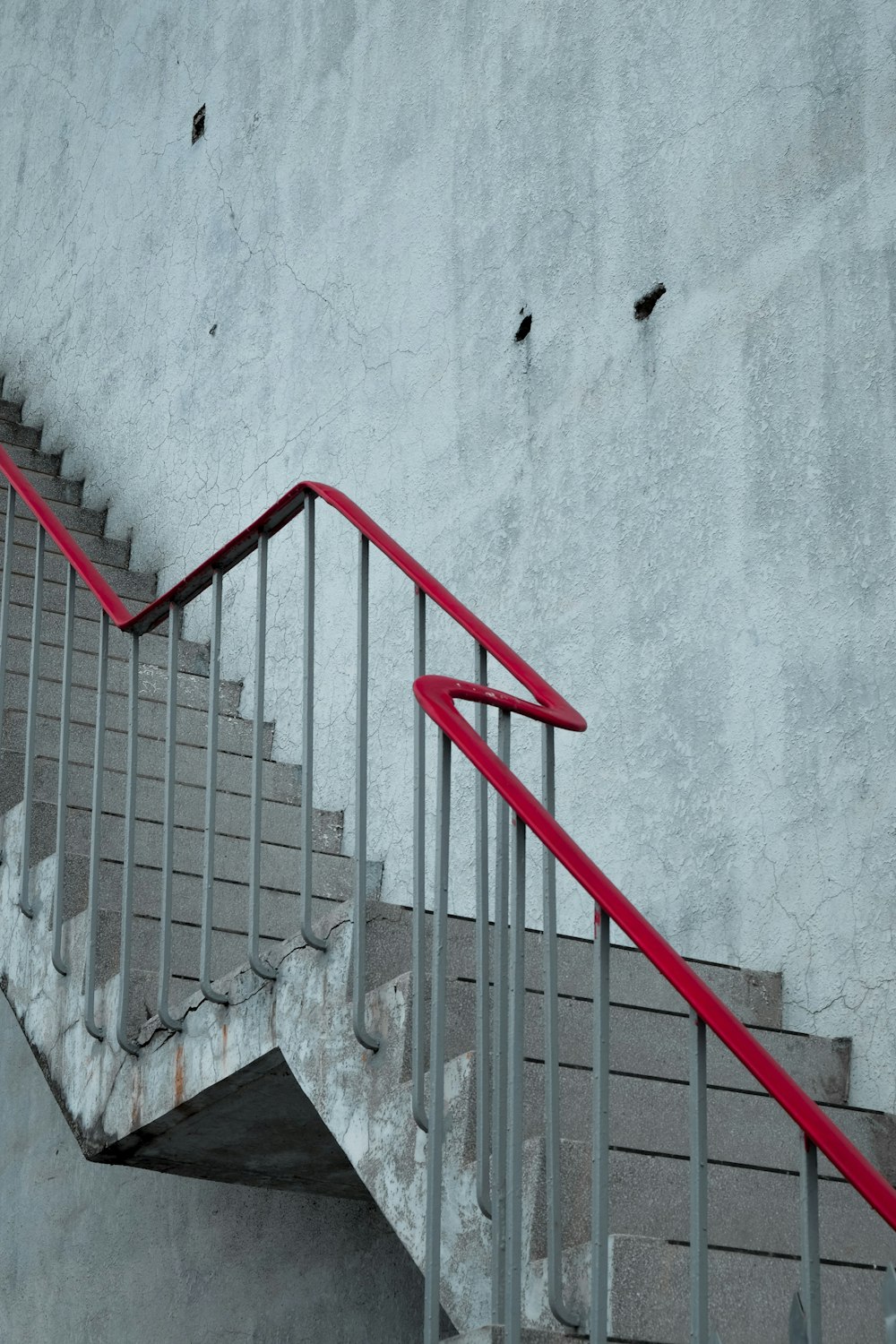 grey and red metal rail stair