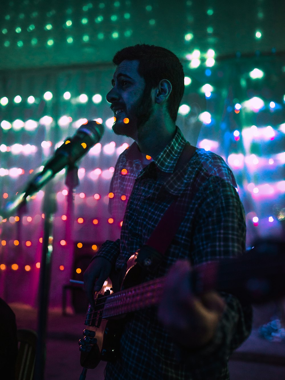 man playing guitar while singing