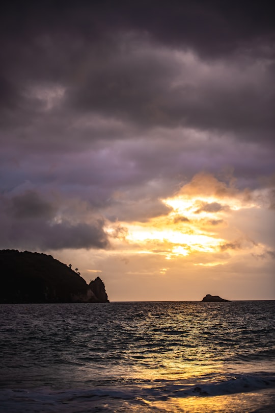 silhouette of island during orange sunset in Hahei Beach Road New Zealand